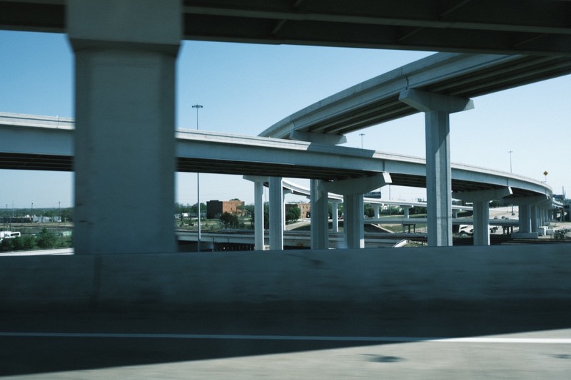 Concrete flyovers curving and stacking overhead.